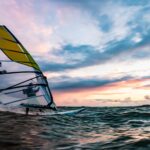 yellow and white sail boat on sea during daytime