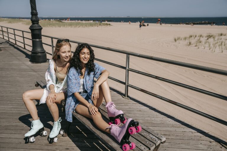 Girls in Rollers Sitting on Bench on Beach