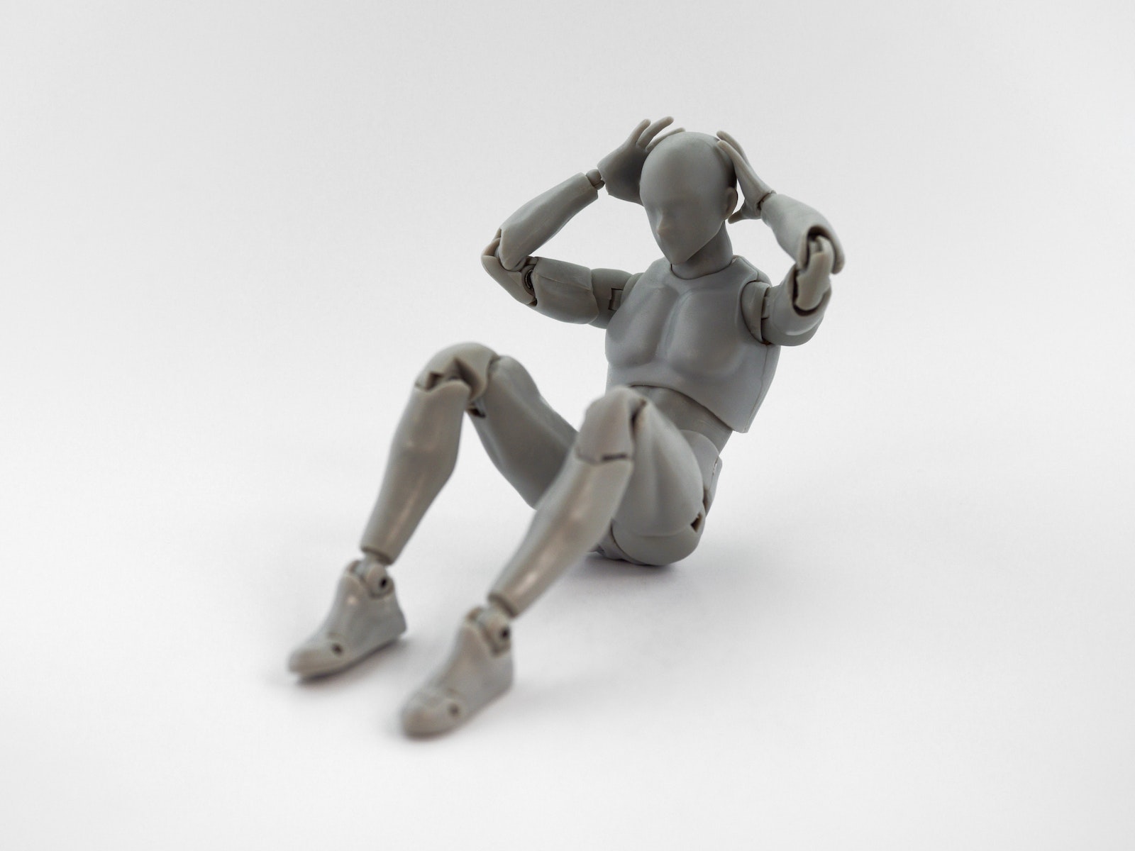 A Robot Figure Doing a Sit-up