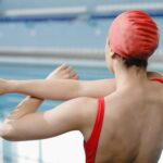 A Woman in Red Swimsuit and Red Swim Cap