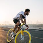 man riding bicycle on road during daytime